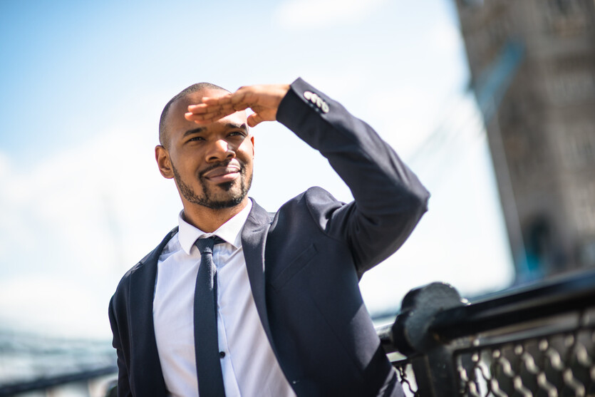 Young Black professional looking out to the skyline