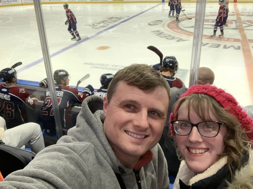 Ashley Plyushko, CPA and her husband at a hockey game